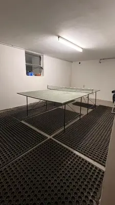 a ping pong table sitting on the floor in a room at Villa for a get away in Soprabolzano