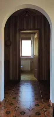 an empty room with a hallway with a window at Villa for a get away in Soprabolzano