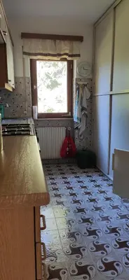 a kitchen with a tile floor and a window at Villa for a get away in Soprabolzano