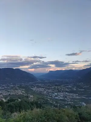 a view of a city with mountains in the distance at Culinaria living in Tirolo