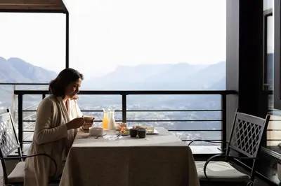 a woman sitting at a table with a bowl of food at Culinaria living in Tirolo