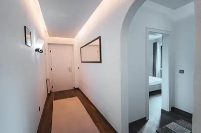 a hallway with white walls and a white door at Majestic Apartment by Majestic Resorts Dolomites in Riscone