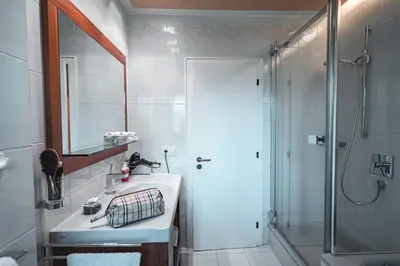 a bathroom with a shower and a sink and a mirror at Majestic Apartment by Majestic Resorts Dolomites in Riscone