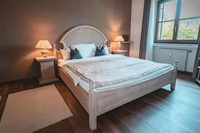 a bedroom with a large bed with two night stands at Majestic Apartment by Majestic Resorts Dolomites in Riscone