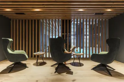 a room with three chairs and tables in front of a window at Laurena Aparthotel in Naz-Sciaves
