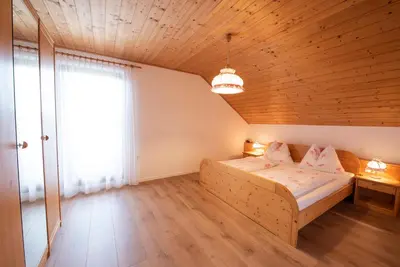 a bedroom with a bed and a large window at Marolhof in Cornaiano