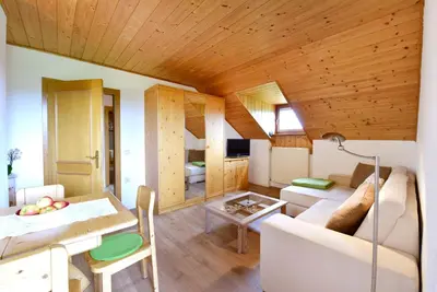 a living room with a couch and a table at Marolhof in Cornaiano