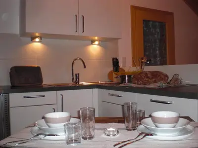 a kitchen with a table with dishes on it at Ferienwohnung Boarbichlhof in Schenna