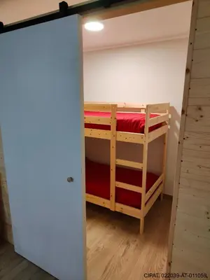 a room with two bunk beds and a closet at Pordoi H10 - with SAUNA in Alba di Canazei