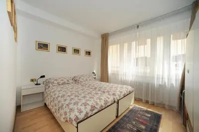 a small bedroom with a bed and a window at Appartamento Dolomiti in Predazzo