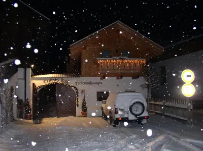 a car parked outside of a house in the snow at Luggishof in Campo Tures