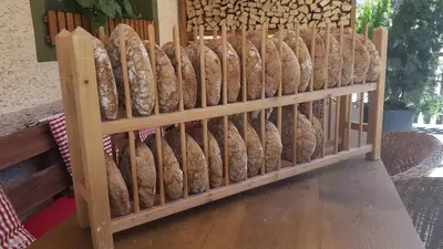a bunch of loaves of bread on display in a store at Luggishof in Campo Tures