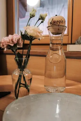 two vases with flowers in them on a table at Luggishof in Campo Tures