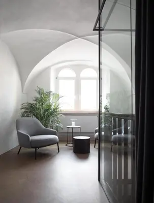 a living room with two chairs and a window at Marktplatz 10 in Caldaro