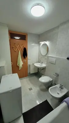 a bathroom with a toilet and a sink and a toilet istg at Apartment Frisch in San Lorenzo di Sebato