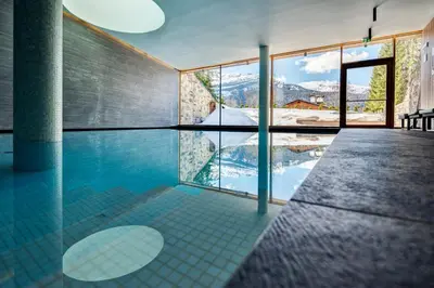 a swimming pool with a view of the mountains at Hotel Lajadira & Spa in Cortina dʼAmpezzo