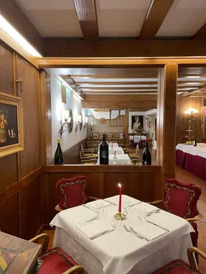 a dining room with a table with a candle on it at Hotel Lajadira & Spa in Cortina dʼAmpezzo