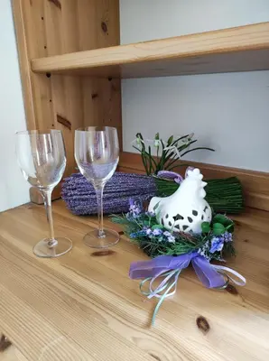 three wine glasses and a vase on a table at Appartamento Vanoi nel cuore verde del Trentino in Canale San Bovo