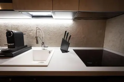 a kitchen counter with a sink and a microwave at Cesa Ardon 1 in Campitello di Fassa