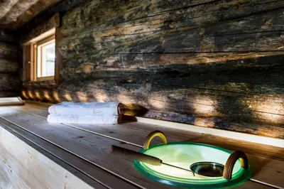 a green bowl on a table in a wooden cabin at Hotel Rosa Eco Alpine Spa in Alpe di Siusi