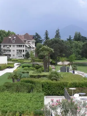 a house with a garden in front of a building at Villa Doris in Merano