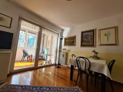 a dining room with a table and chairs and a television at Villa Doris in Merano