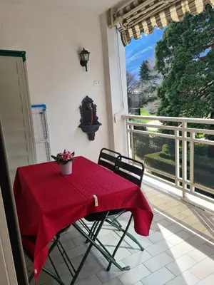 a table with a red table cloth on a balcony at Villa Doris in Merano