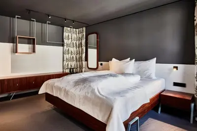 a bedroom with a large bed with white sheets at Bettstadt Apartments in Vipiteno