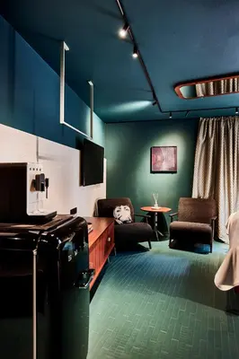 a room with blue walls and chairs and a table at Bettstadt Apartments in Vipiteno