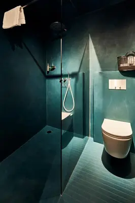 a bathroom with a toilet and a glass shower at Bettstadt Apartments in Vipiteno