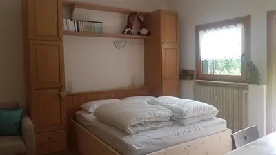 a bed with white pillows on it in a room at La Casa degli Gnomi in Falcade
