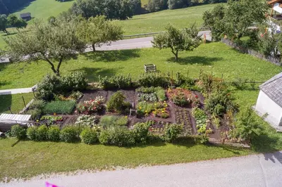an aerial view of a garden with flowers and plants at Kuenhof in San Sigismondo