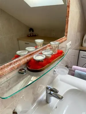a glass shelf above a sink with bowls on it at Kuenhof in San Sigismondo