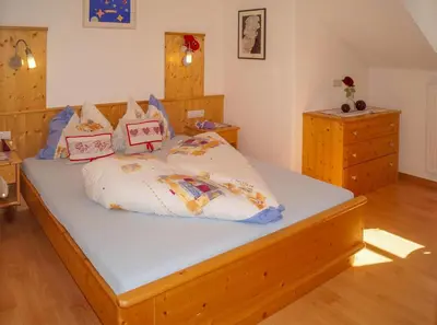 a bedroom with a bed with pillows on it at Kuenhof in San Sigismondo
