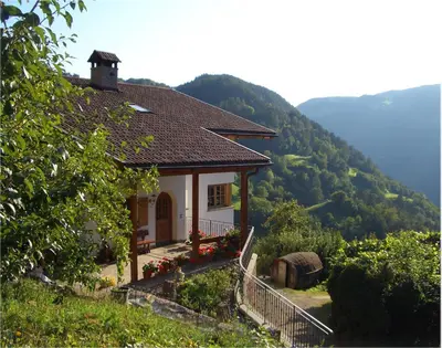 a small house on the side of a mountain at Lafreiderhof in Castelrotto