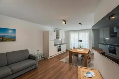a living room with a couch and a table at Residence Alpina in Tesimo