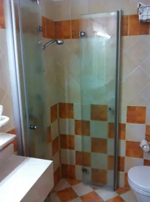 a shower with a glass door in a bathroom at Piccolo Hotel Sciliar in Alpe di Siusi