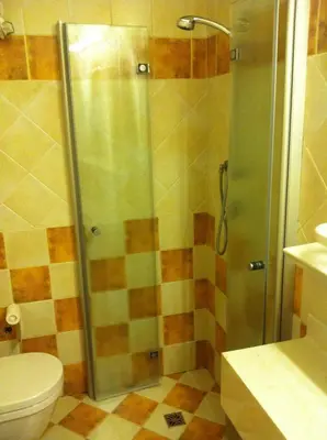 a bathroom with a shower and a toilet at Piccolo Hotel Sciliar in Alpe di Siusi
