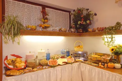 a table with a buffet of food on it at Piccolo Hotel Sciliar in Alpe di Siusi