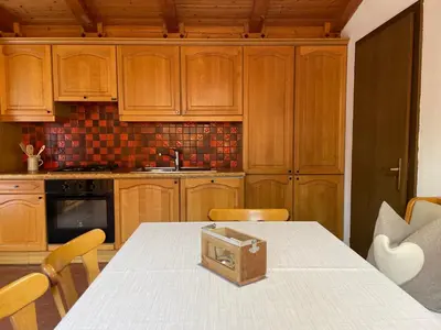 a kitchen with a table with a box on it at Chalet Forciagn in San Vigilio Di Marebbe