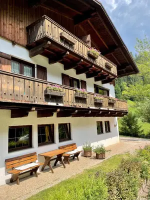 a building with two benches and a balcony at Chalet Forciagn in San Vigilio Di Marebbe