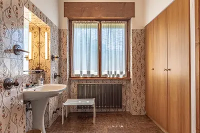 a bathroom with a sink and a window at Dolomites White Rest - Mountain View in Tres