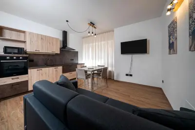 a living room with a couch and a dining room at Cauriol Suites 1.1 in Cavalese