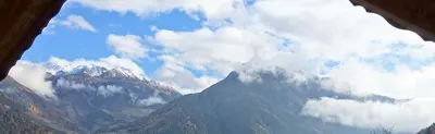 a view of a mountain range with clouds in the sky at Pretzerhof in Campo di Trens