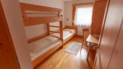 a room with two bunk beds and a window at Pretzerhof in Campo di Trens