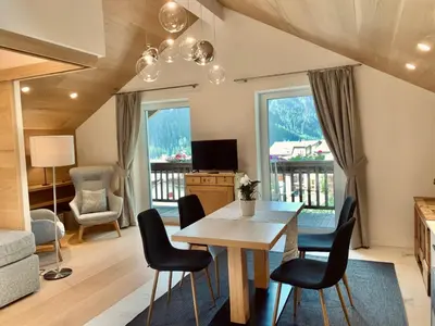 a living room with a dining room table and chairs at Eurochalet in Campitello di Fassa