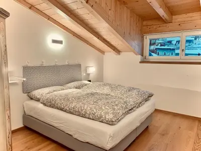 a bedroom with a bed and a window at Eurochalet in Campitello di Fassa
