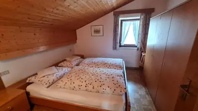 a bedroom with a bed in a room with a window at Apartment Weissenegger in Fiè