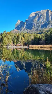 a reflection of a mountain in a lake at Apartment Weissenegger in Fiè