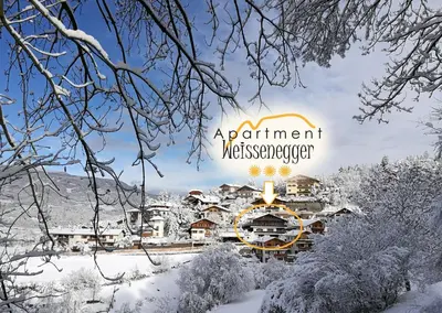 a winter view of a resort with snow covered trees at Apartment Weissenegger in Fiè